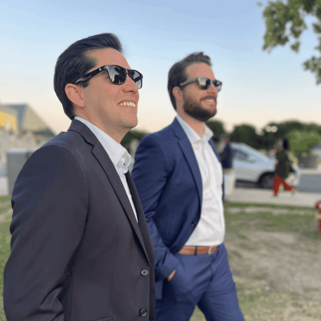 two men in blazers wearing branded sunglasses relating to creating a brand activation people can wear