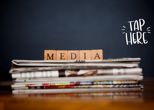 blocks spelling media on top of stacked newspapers relating to paid vs. earned media