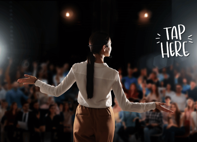 woman standing on stage relating to using public speaking for lead generation