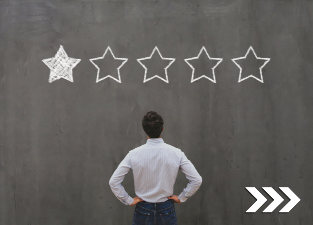 man staring at wall with a 1 out of 5 star rating painted above him relating to negative reviews