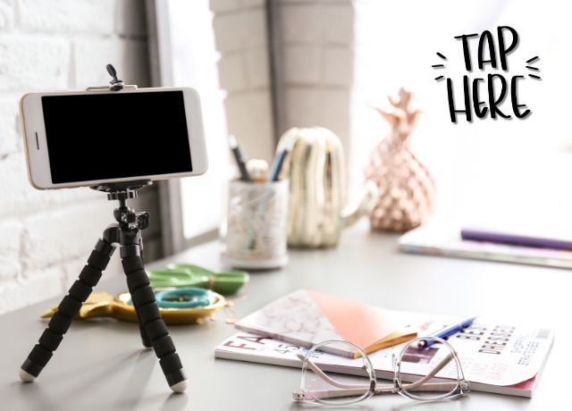 cell phone on tripod on top of desk with papers and eyeglasses relating to quick content creation
