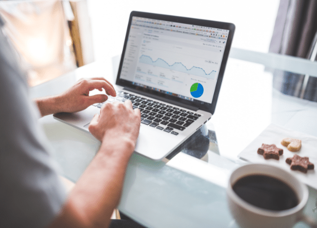 hands on keyboard looking at chart relating to digital advertising performance