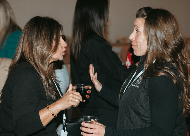two people networking at an event related to turning connections into revenue
