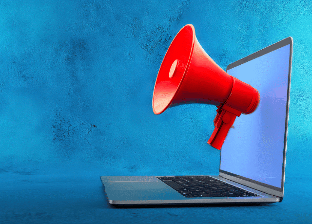 red magphone emerging from laptop screen relating to website announcement campaign