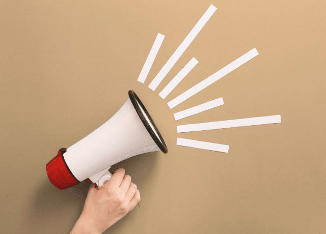 hand holding a megaphone and shouting like how a logo represents a brand visually