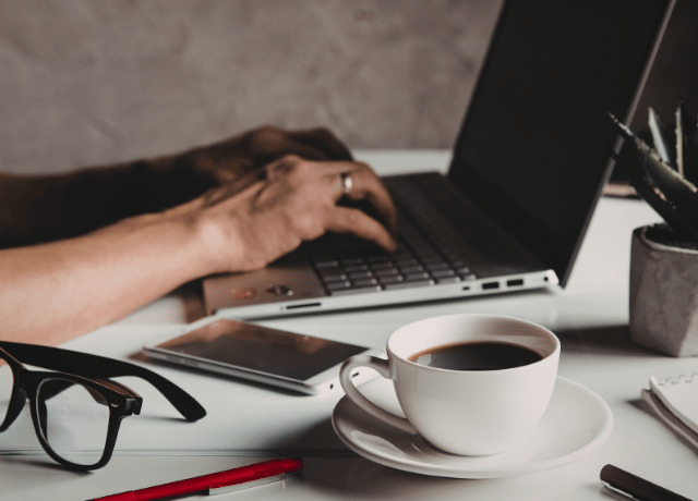 hands over laptop keyboard relating to developing content pillars for stronger content marketing