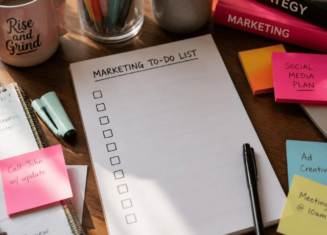 cluttered desk with blank marketing to do list relating to not wasting a slow month