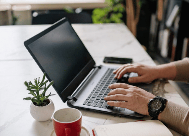 hands over a laptop keyboard relating to the difference between branding, marketing, and public relations